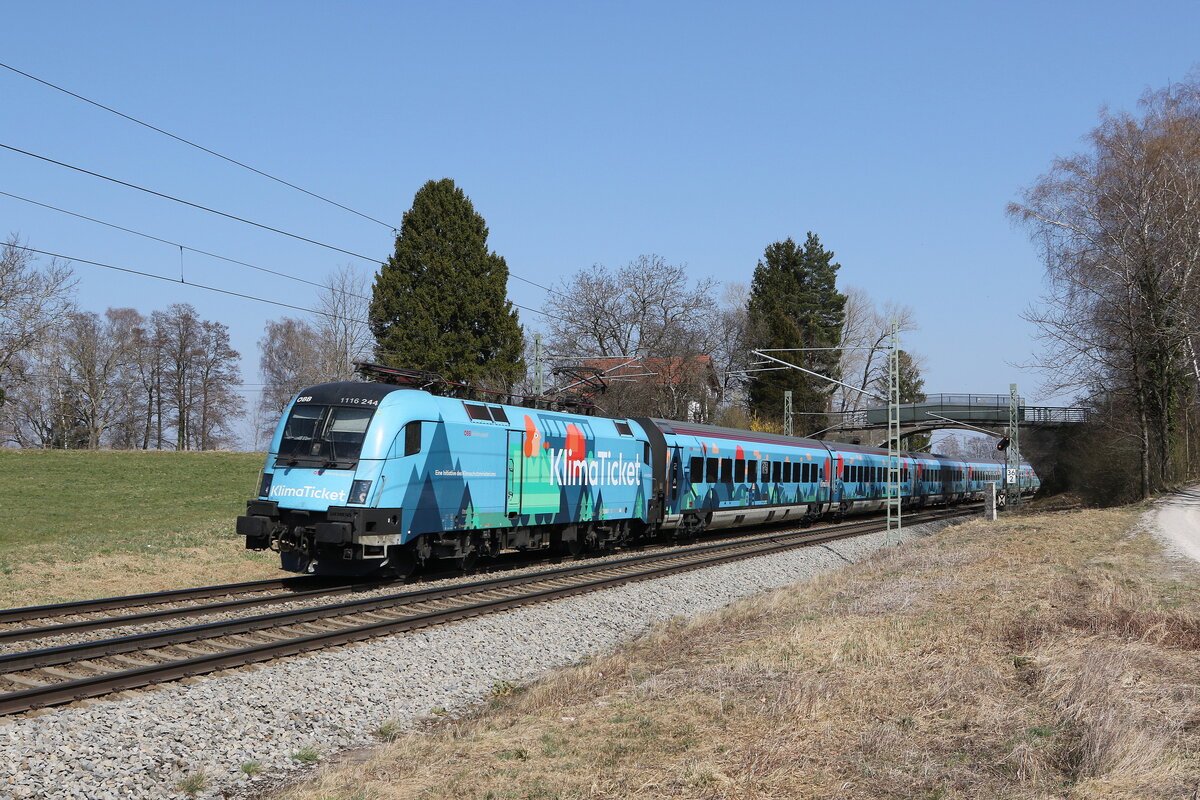 1116 244 mit dem  Klima-Railjet  aus Salzburg kommend am 28. M�rz 2022 bei �bersee am Chiemsee.